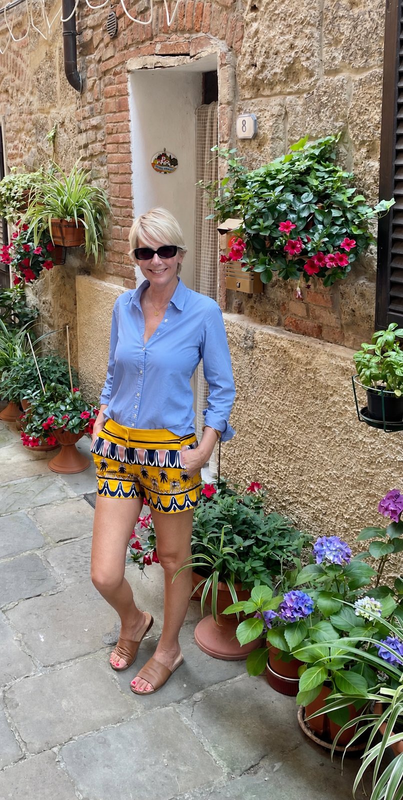 Donna Almeida standing in a stone alley in Città della Pieve, Umbria