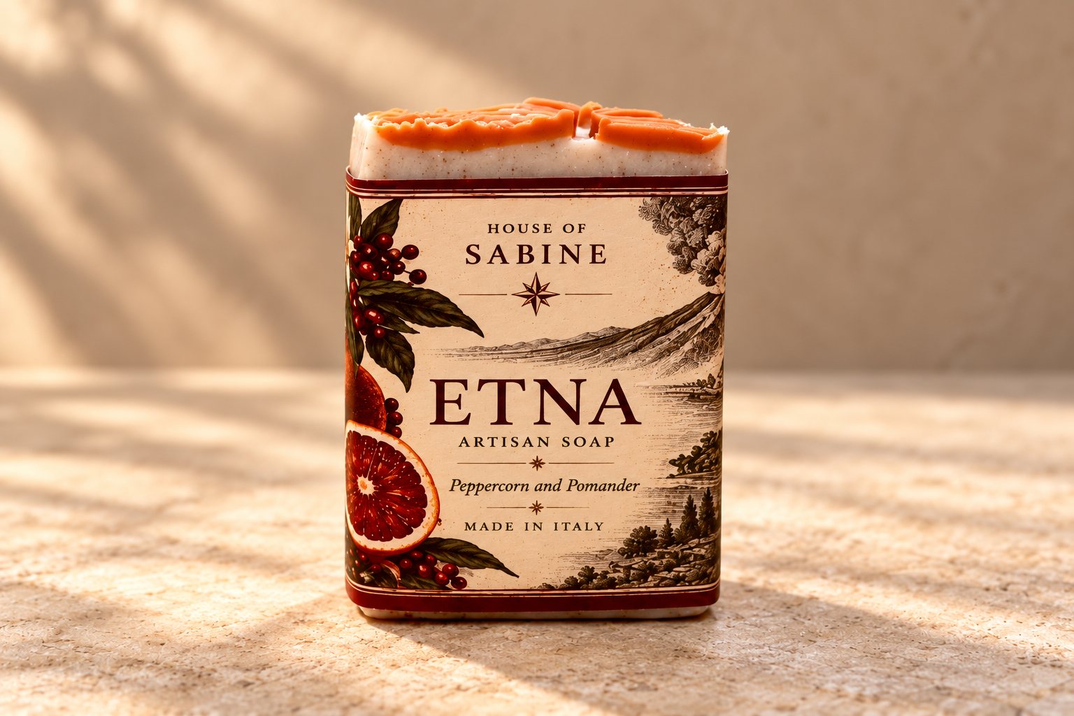 Etna bar in a cream label with blood oranges and an engraving of the volcano, orange-slice top